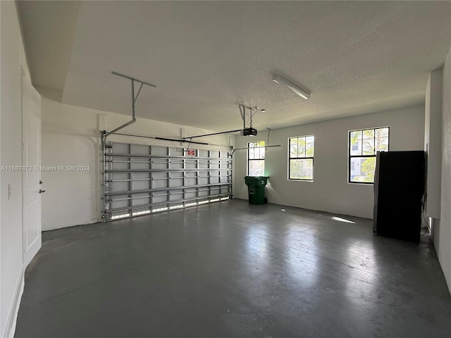 garage featuring refrigerator and a garage door opener