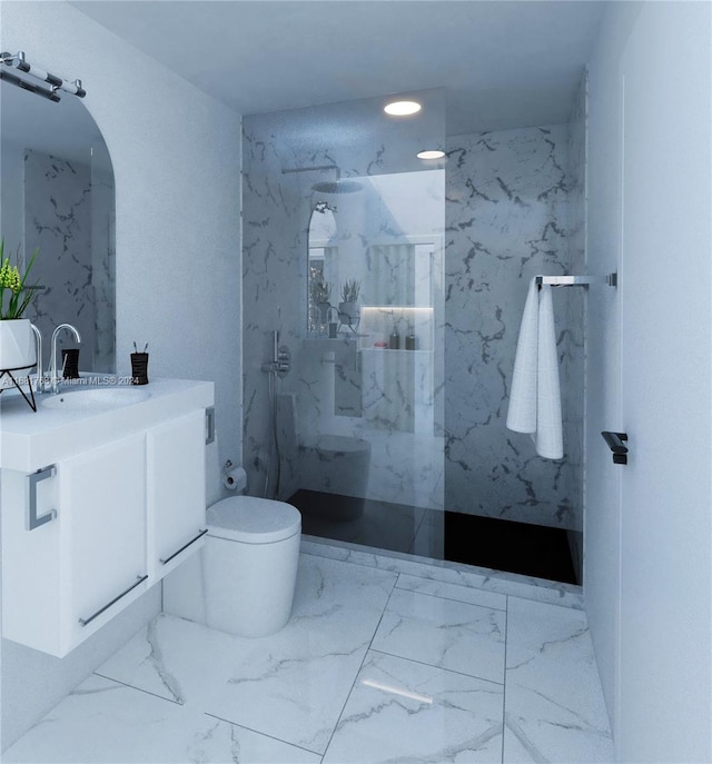 bathroom featuring vanity, a tile shower, and toilet