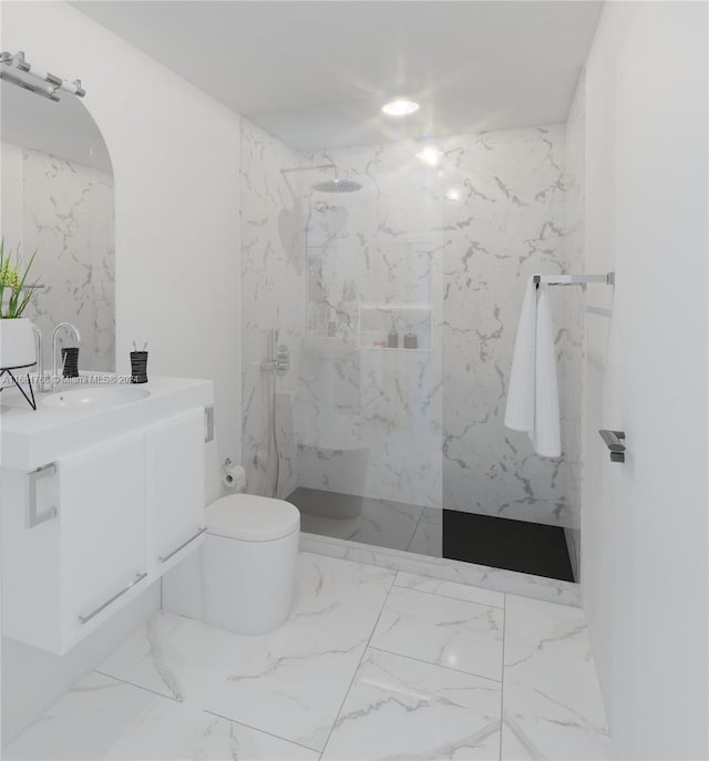 bathroom featuring vanity, a tile shower, and toilet