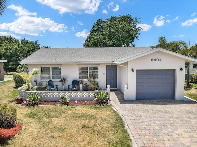 ranch-style house with a front yard and a garage