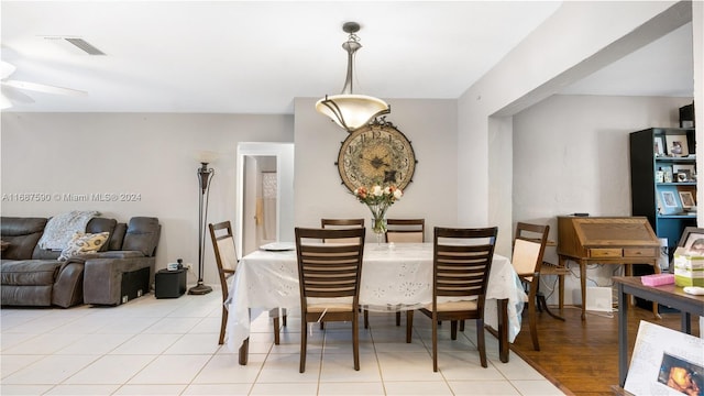 dining area with light hardwood / wood-style flooring and ceiling fan