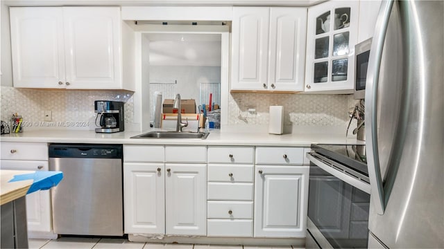 kitchen featuring white cabinetry, appliances with stainless steel finishes, sink, and decorative backsplash