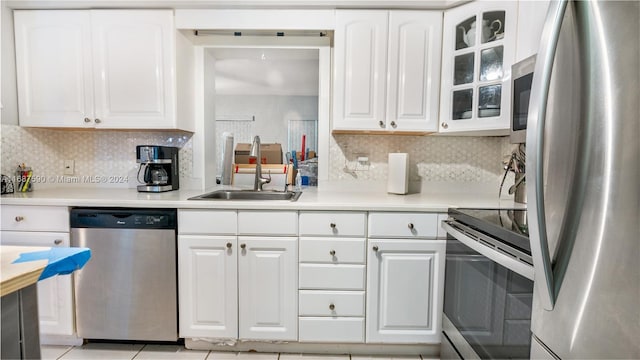 9404 NW 70th Pl, Tamarac, FL 33321 - kitchen with stainless steel appliances, backsplash, and white cabinets