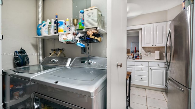 laundry area featuring washer and dryer and light tile patterned flooring