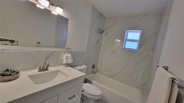 full bathroom with toilet, tiled shower / bath, vanity, and tile walls