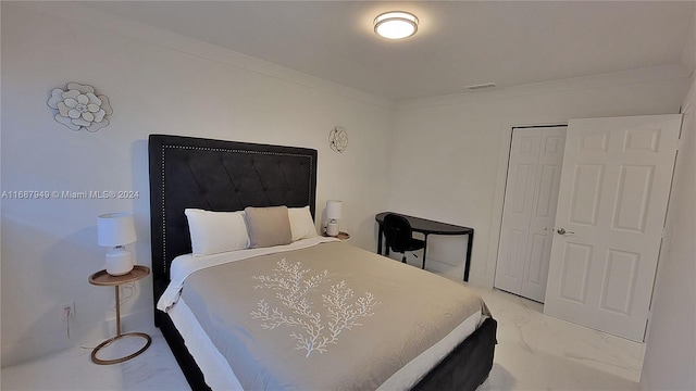 bedroom with crown molding and a closet