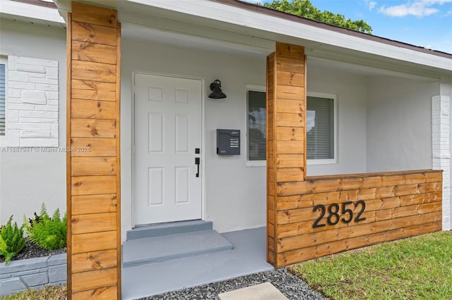 property entrance with covered porch