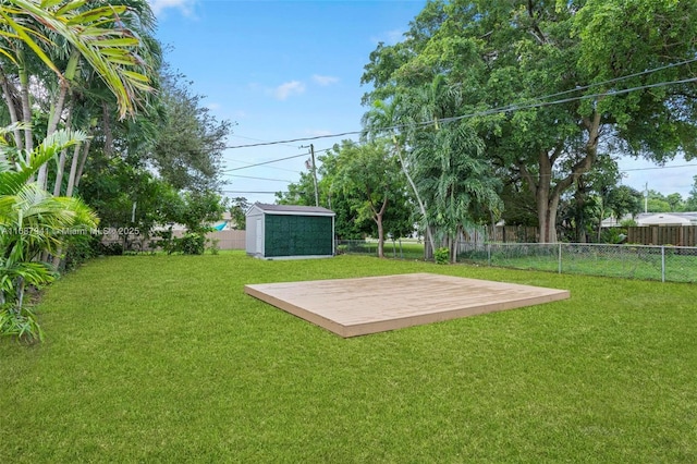 view of yard with a storage shed and a wooden deck