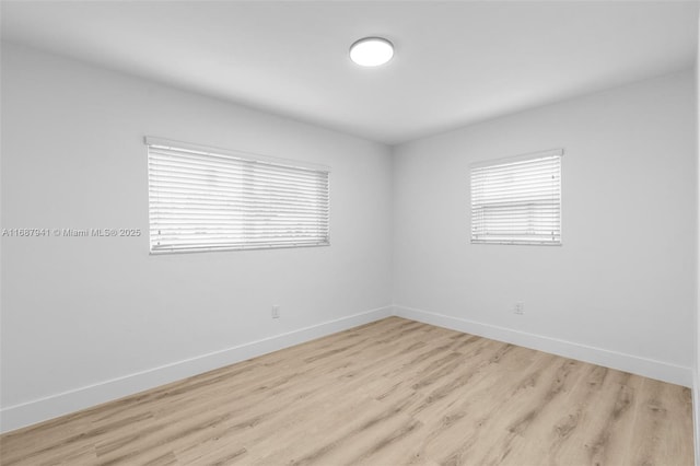 spare room with light hardwood / wood-style flooring