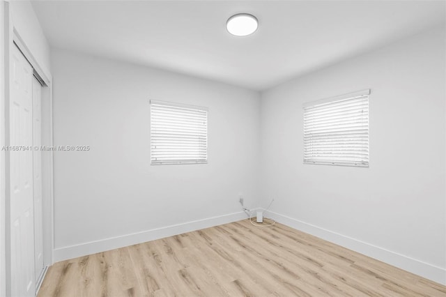 empty room featuring a healthy amount of sunlight and light wood-type flooring