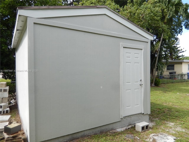 view of outbuilding featuring a yard