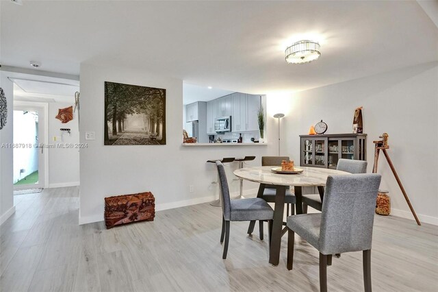 dining area with light hardwood / wood-style flooring