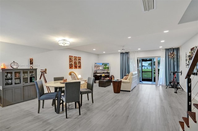 dining space with ceiling fan and light hardwood / wood-style flooring