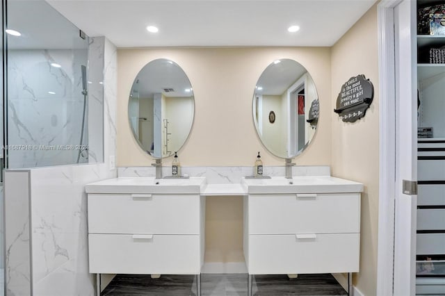 bathroom featuring walk in shower and vanity