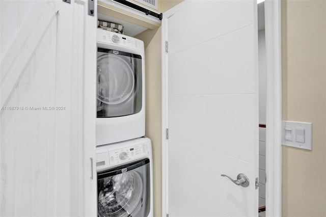 washroom featuring stacked washing maching and dryer