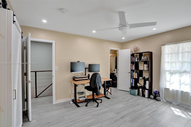 office with ceiling fan and light wood-type flooring