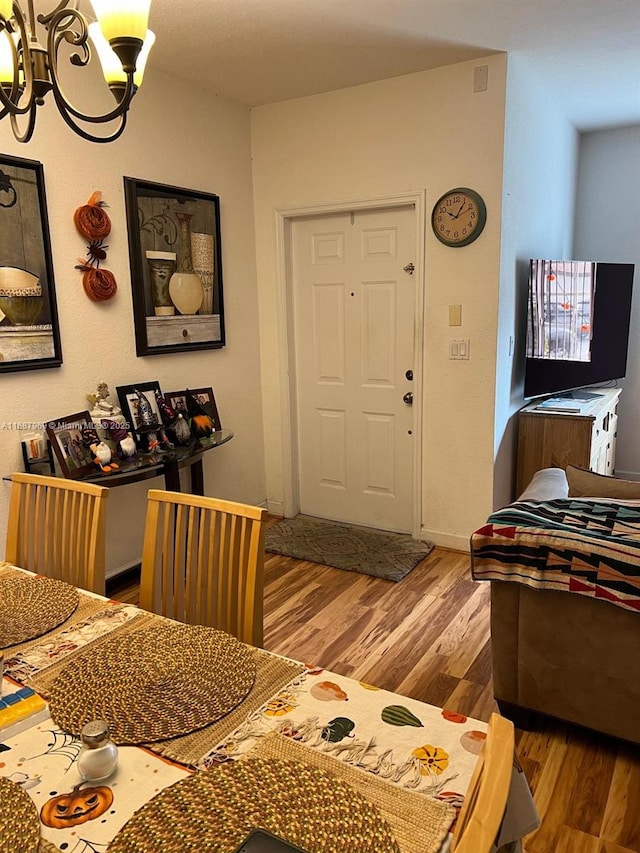 entrance foyer featuring hardwood / wood-style flooring and a chandelier