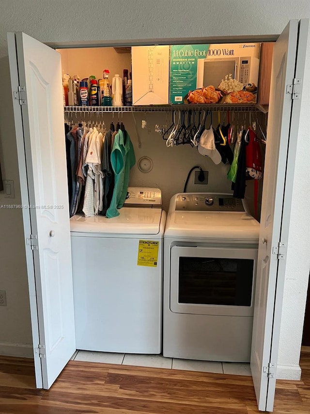 laundry area with hardwood / wood-style flooring and separate washer and dryer