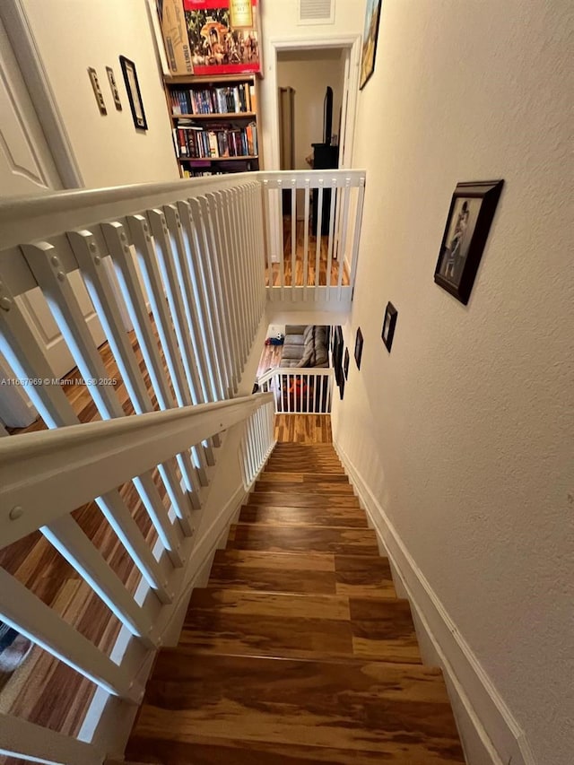 stairs with hardwood / wood-style floors