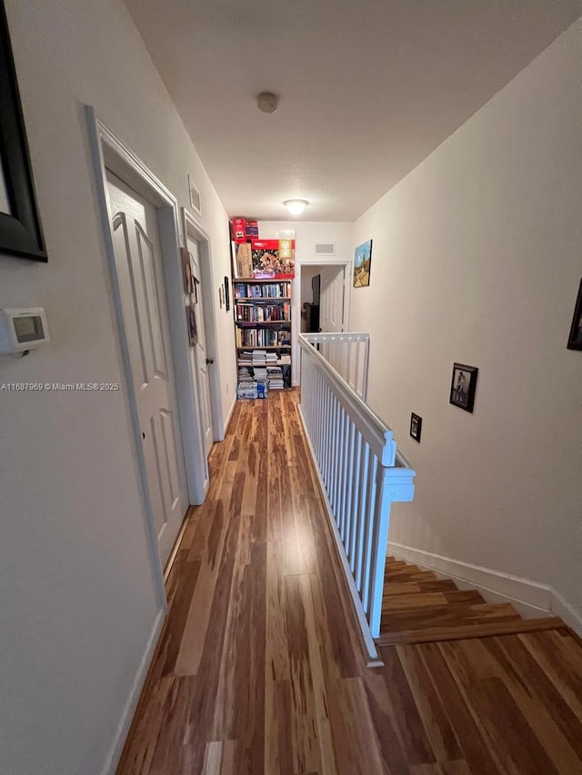 hallway with dark hardwood / wood-style flooring