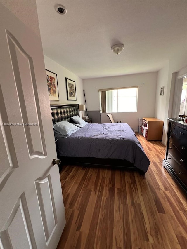 bedroom with hardwood / wood-style floors