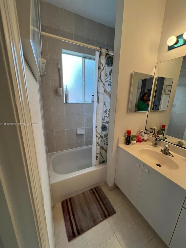 bathroom with shower / tub combo with curtain, vanity, and tile patterned floors