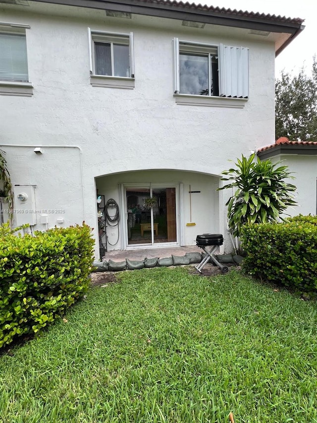 rear view of house with a lawn