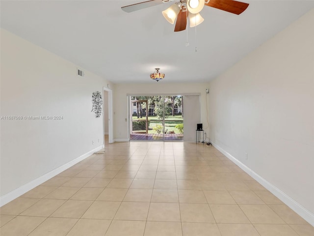 tiled empty room with ceiling fan