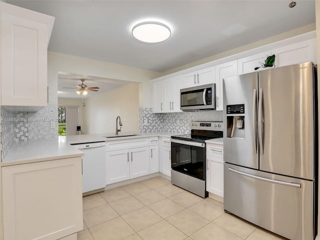 kitchen with decorative backsplash, appliances with stainless steel finishes, sink, and white cabinets