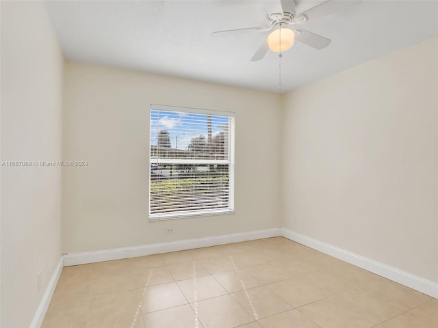 spare room with light tile patterned flooring and ceiling fan