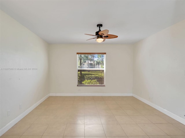 tiled empty room featuring ceiling fan