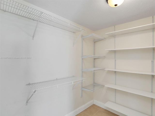 spacious closet featuring light tile patterned floors