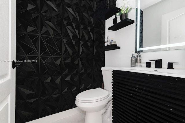 bathroom with tile patterned floors, vanity, and toilet