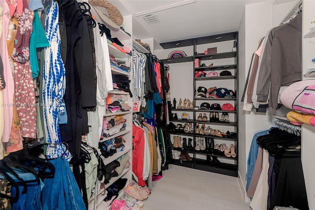 spacious closet featuring light wood-type flooring