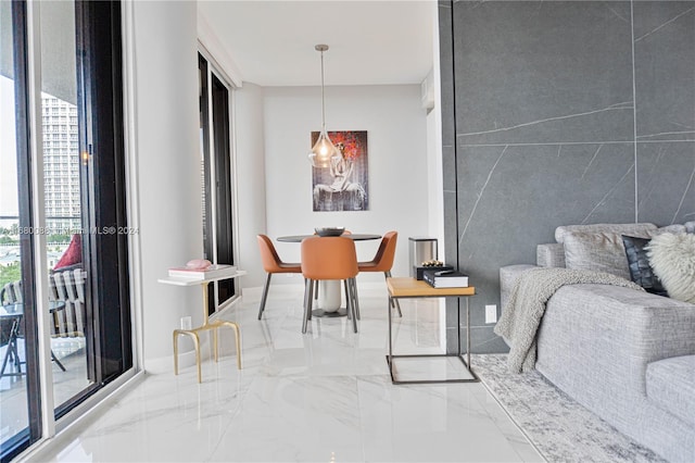 dining room featuring tile walls and a wealth of natural light