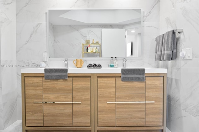 bathroom featuring tile walls and vanity