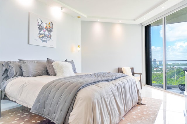 bedroom featuring expansive windows, tile patterned flooring, and access to outside