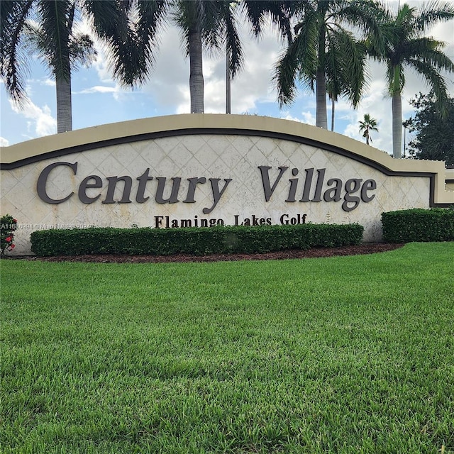 community sign featuring a lawn