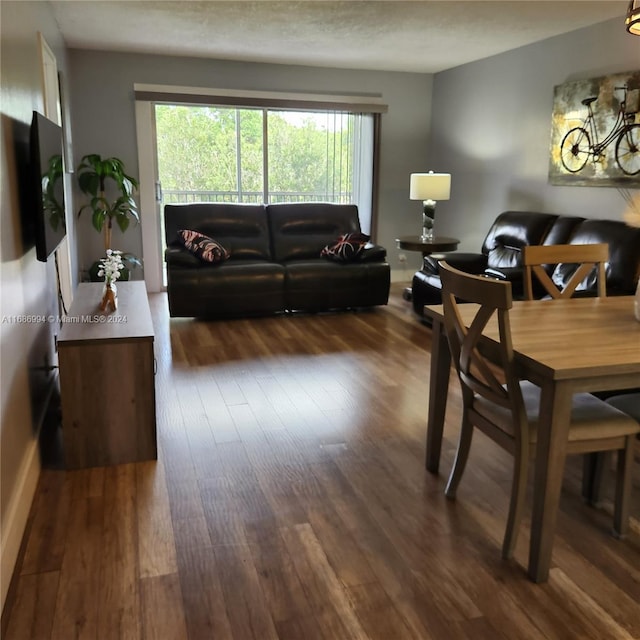 living room featuring dark hardwood / wood-style floors and a textured ceiling