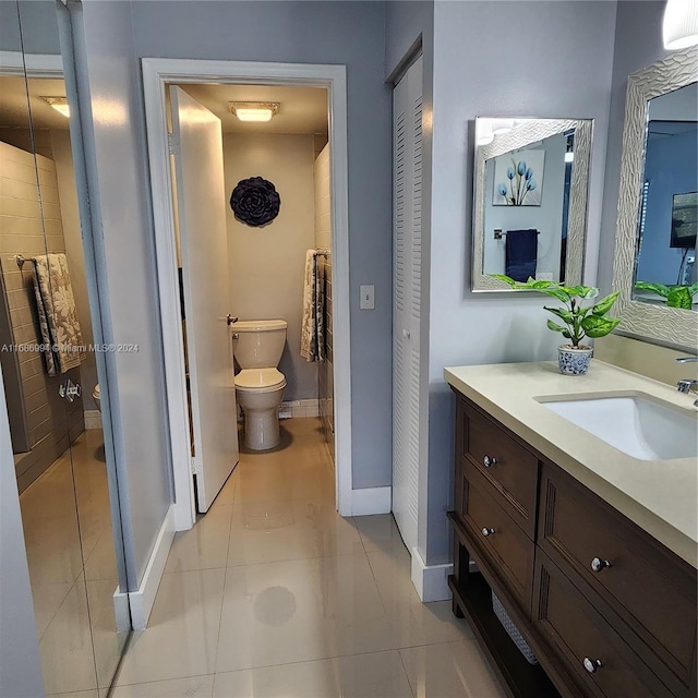 bathroom featuring tile patterned flooring, vanity, and toilet