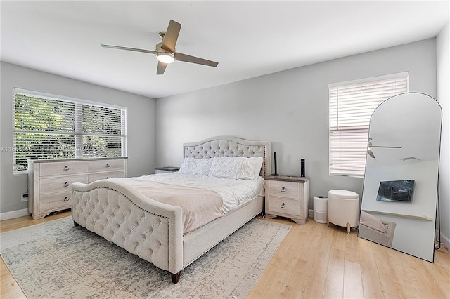 bedroom with light hardwood / wood-style floors and ceiling fan