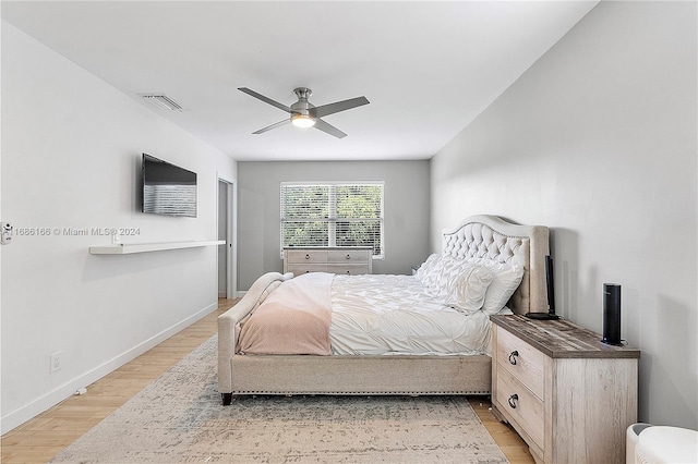 bedroom with light hardwood / wood-style flooring and ceiling fan