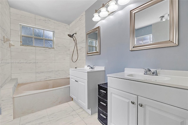 bathroom featuring vanity and tiled shower / bath