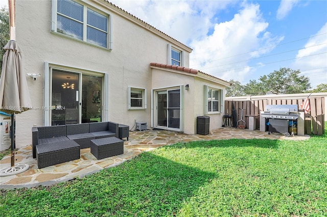 rear view of property with a yard, a patio, and an outdoor hangout area