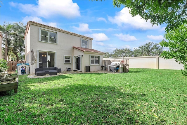 rear view of house featuring a yard, outdoor lounge area, a patio, and central AC