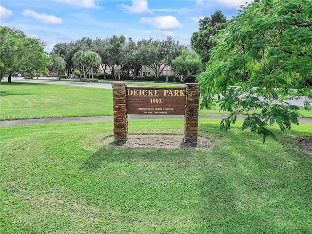 community / neighborhood sign with a yard