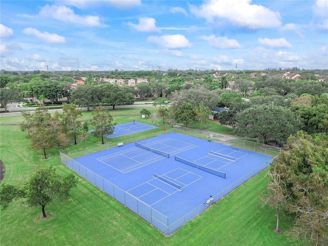 view of tennis court with a lawn