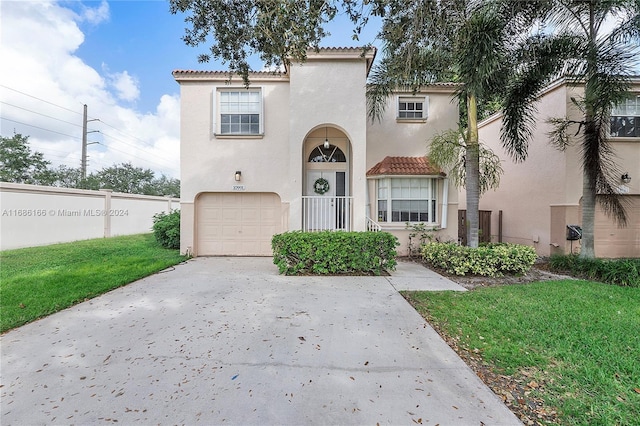 mediterranean / spanish-style house with a garage and a front lawn