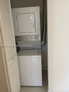 laundry room with stacked washer / dryer