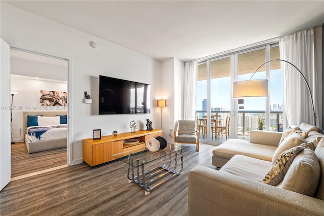 living room with a wall of windows and hardwood / wood-style floors